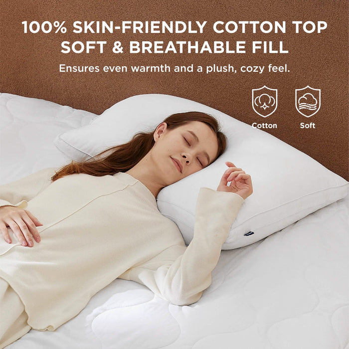 Woman sleeping on a soft, 100% cotton heated mattress pad with breathable fill for cozy comfort.