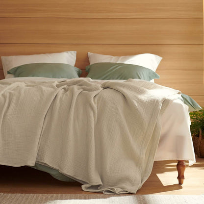 GentleSoft 100% Cotton Gauze Spring Throw Blanket draped on a bed.