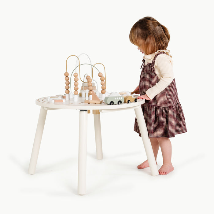 Biscotti@Child using an activity table for hands-on creative play