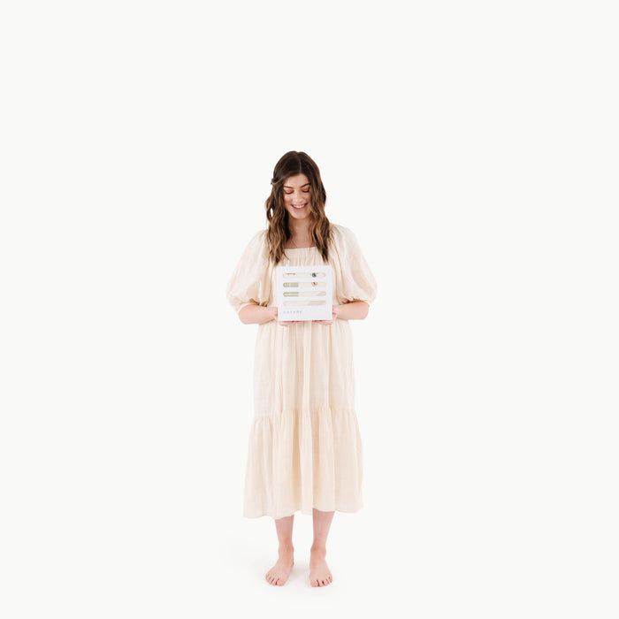 Boulevard@Woman holding a Boulevard Mini+ Mat in white Gathre packaging