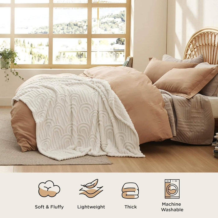 GentleSoft Arch Shaggy Sherpa Fleece Blanket in cream draped on a bed, showcasing plush texture and arch pattern.