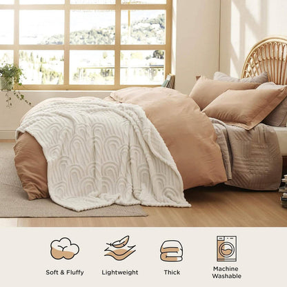 GentleSoft Arch Shaggy Sherpa Fleece Blanket in cream draped on a bed, showcasing plush texture and arch pattern.