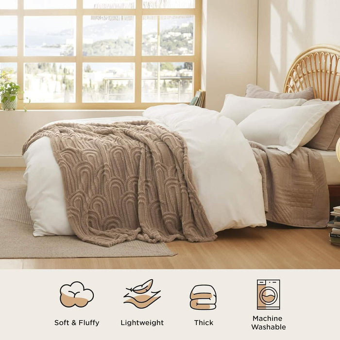 Taupe GentleSoft Arch Shaggy Sherpa Fleece Blanket with raised arch pattern on a bed, showcasing plush texture.