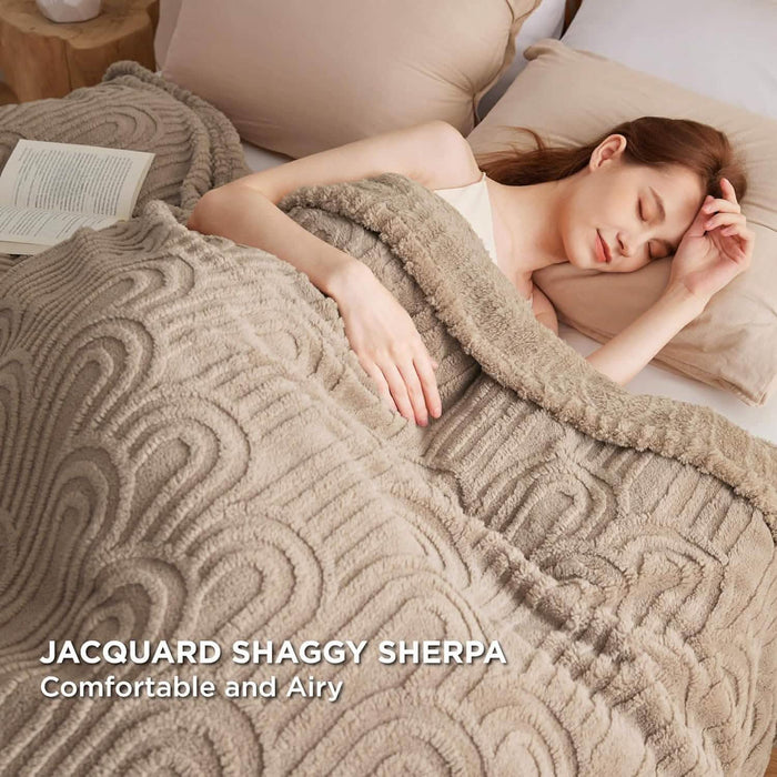 Taupe GentleSoft Arch Shaggy Sherpa Fleece Blanket with raised arch pattern, on bed, woman sleeping, plush texture, comfort.