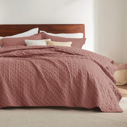 GentleSoft rose basket-weave quilt set on bed with shams, showcasing soft polyester microfiber texture.
