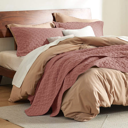 GentleSoft rose quilt set with basket weave texture on a bed, featuring soft polyester microfiber material.