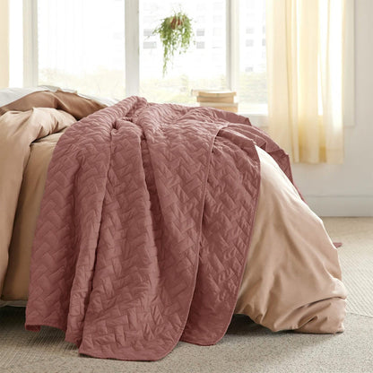 Dusty rose GentleSoft basket-weave quilt set on a bed, polyester microfiber texture.