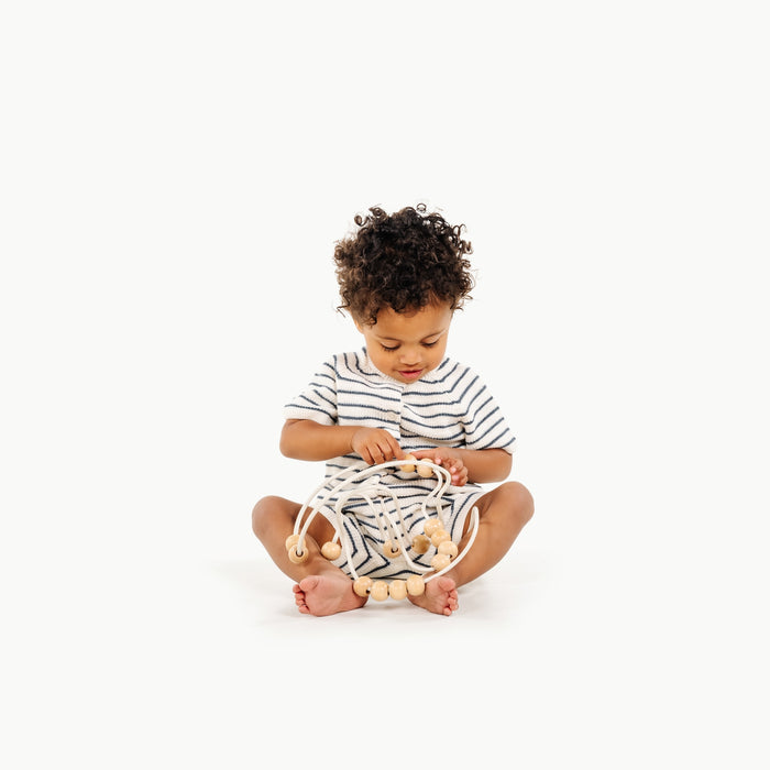 Ivory / Circle@Baby engaging with bead maze to build hand-eye coordination