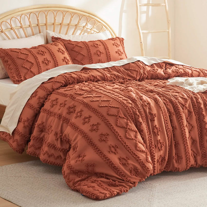 GentleSoft boho burnt orange comforter set with embroidered diamond and line patterns on a bed.