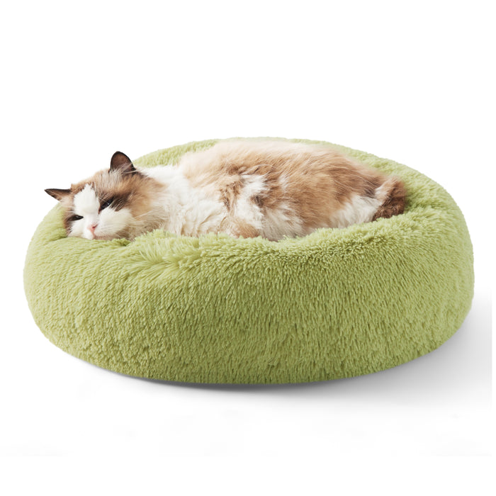 Ragdoll cat napping in plush light green donut pet bed, showing comfort and support.