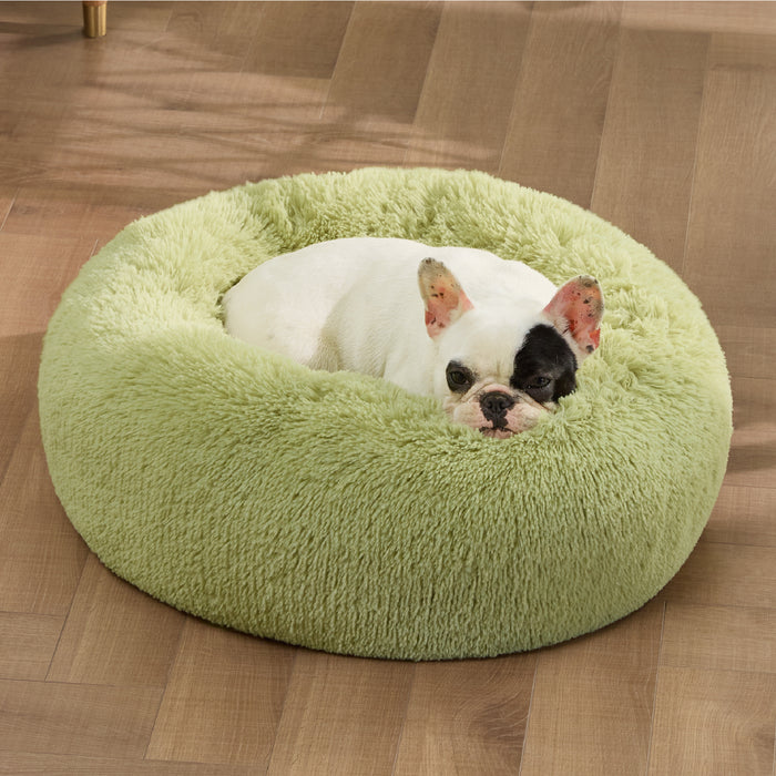 White French Bulldog resting in plush light green donut pet bed, showcasing soft faux shag fur and comforting design.