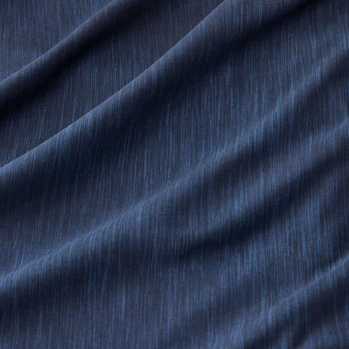 Navy blue GentleSoft comforter fabric close-up showing subtle dual-tone linear texture from cationic dye.