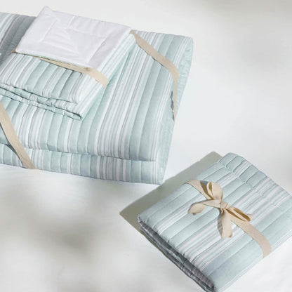 GentleSoft Chill Vibes Quilt Set, light blue and white striped, folded with decorative ribbon, product display.