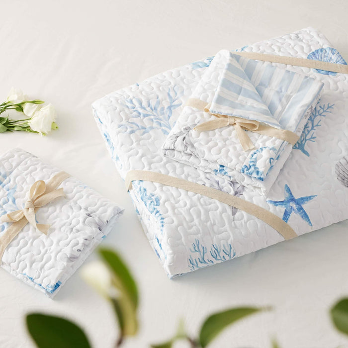 GentleSoft Chill Vibes Quilt Set, blue and grey nautical print microfiber, folded with beige ribbon, product display.