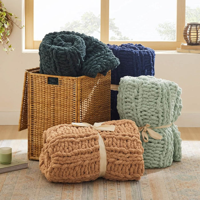 Four GentleSoft chunky knit chenille blankets: deep green, navy, mint green, tan. Thick knit texture, home decor display.
