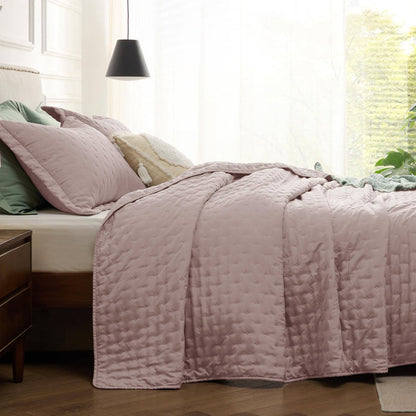 Rose GentleSoft Clover Ultrasonic Quilt Set with embossed pattern on a styled bed, featuring green and cream pillows.