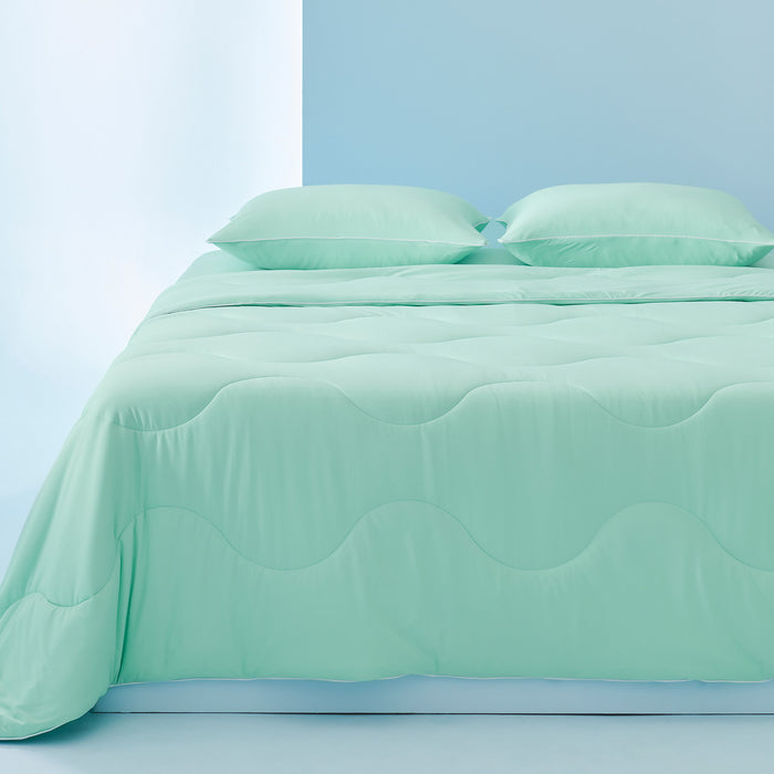 GentleSoft cooling comforter set in mint green, featuring wave quilting, two pillowcases and fitted sheet on a bed.