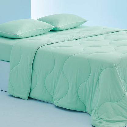 GentleSoft Cooling Comforter Set, mint green, wave quilting, comforter and 2 pillowcases with white piping on bed.