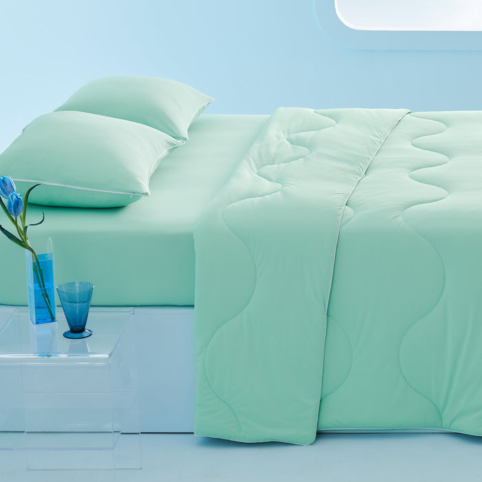 GentleSoft cooling comforter set in mint green, wave quilting, includes comforter, 2 pillowcases, fitted sheet on bed.