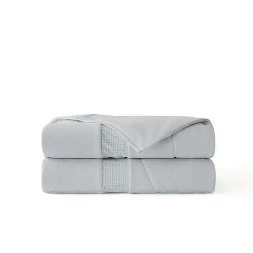 Cooloxy Breathable Cooling Comforter folded, featuring soft textured fabric and perforated ventilation band.