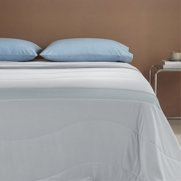 Cooloxy cooling comforter: breathable, light grey, with textured stripe and wavy stitching.