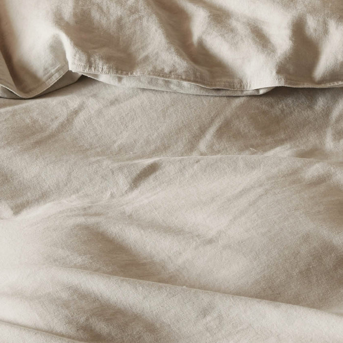 GentleSoft light beige cotton linen duvet cover close-up texture. Soft, breathable, prewashed fabric for bedding.