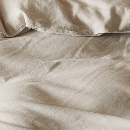 GentleSoft light beige cotton linen duvet cover close-up texture. Soft, breathable, prewashed fabric for bedding.
