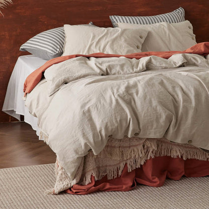 GentleSoft Cotton Linen Duvet Cover Set in light beige with relaxed texture and button closures on a cozy bed.