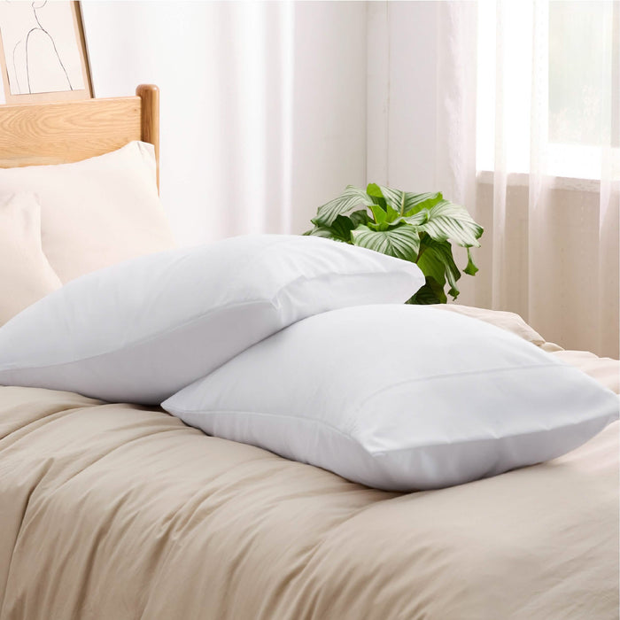 Two white GentleSoft microfiber pillowcases with envelope closure on tan bedding.