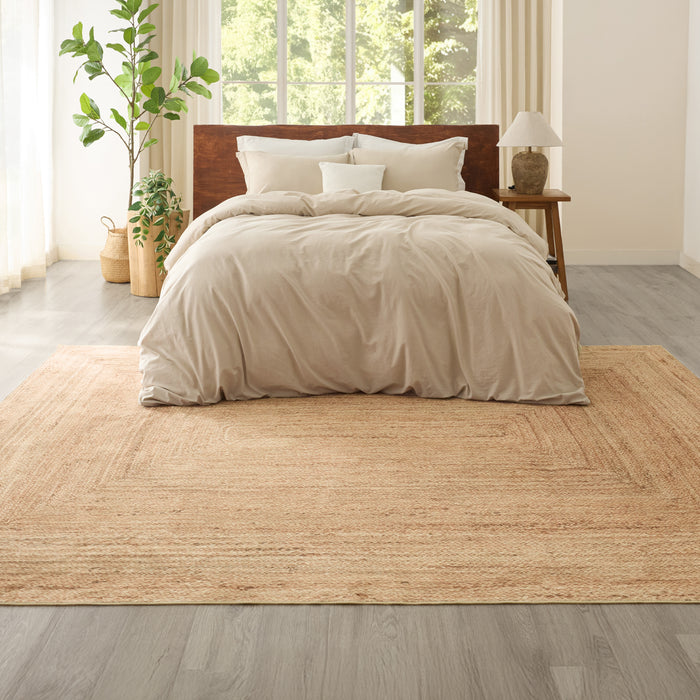 Faux cashmere jute-look area rug with natural woven texture and border pattern.