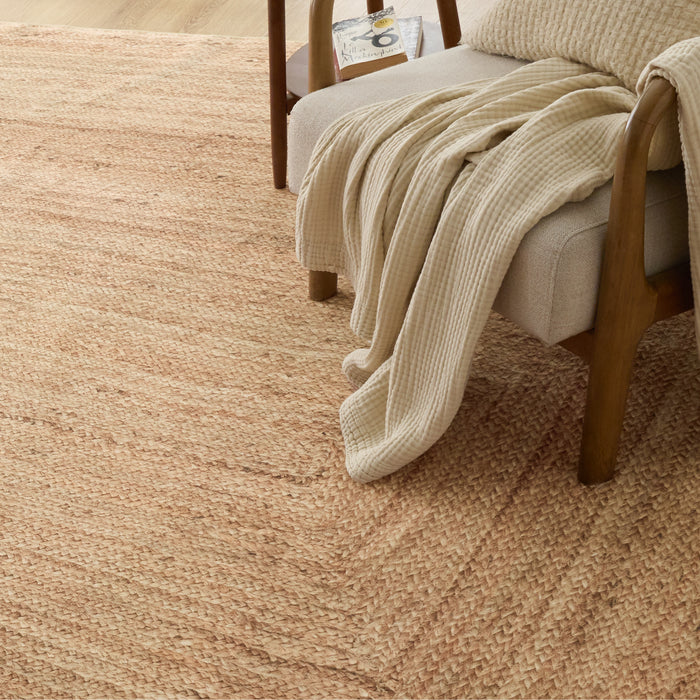 Soft beige faux cashmere jute-look area rug with natural woven texture.