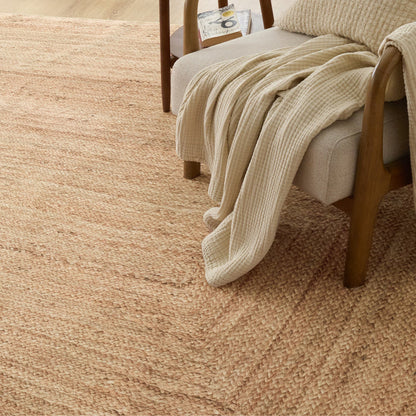 Soft beige faux cashmere jute-look area rug with natural woven texture.