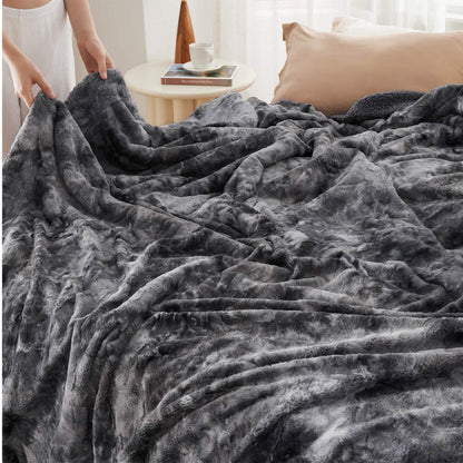 Dark grey marbled GentleSoft Faux Fur Sherpa blanket on bed, showcasing plush texture and cozy Sherpa side.