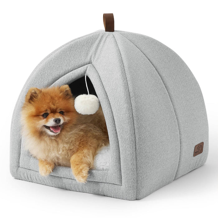 Light gray faux-linen cat dog tent with a Pomeranian peeking out, featuring a hanging pom-pom toy and leatherette handle.