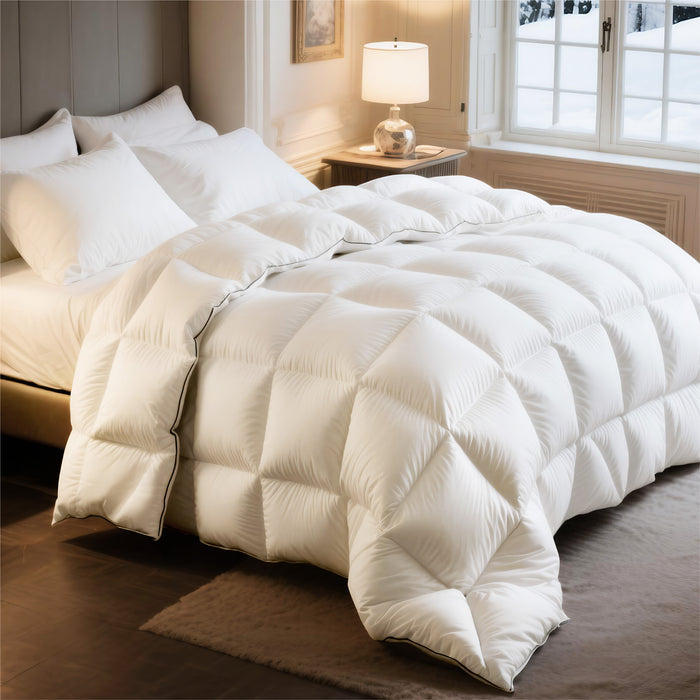 Plush white PureWoven feather down comforter with diamond box quilting and black piping.