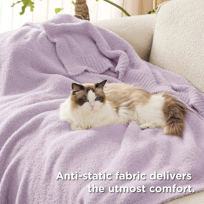 GentleSoft light lavender feather yarn throw blanket with plush texture on a cream sofa, with a Ragdoll cat lounging.