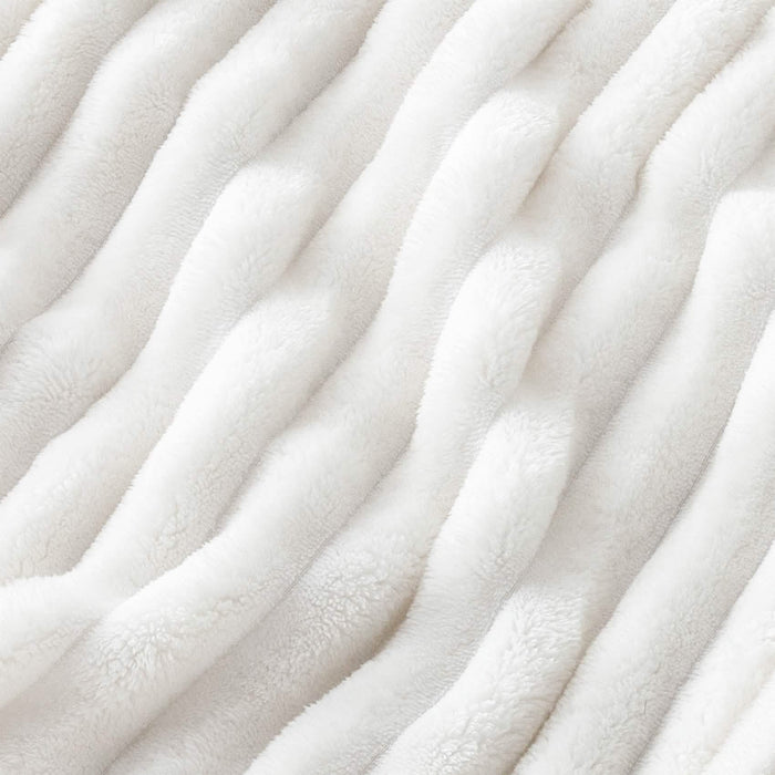 Off-white GentleSoft® plush polyester blanket with ribbed texture.