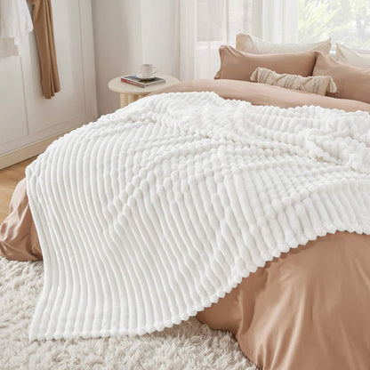 Off-white GentleSoft® blanket with plush, ribbed texture and soft feel.