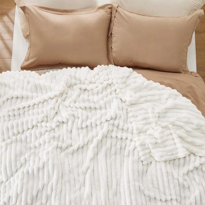 GentleSoft® textured white plush blanket, designed for extra fluff and comfort.