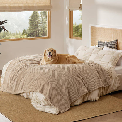 Golden retriever relaxing on a light brown chevron pattern Jacquard fleece pet blanket on a bed in a cozy room.