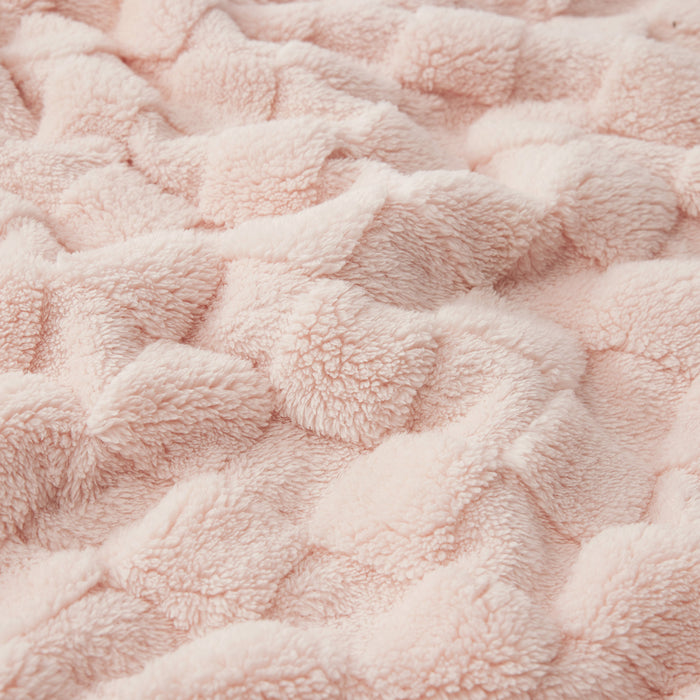 Close-up of pink GentleSoft sherpa blanket showing shaggy texture and checkerboard jacquard weave.