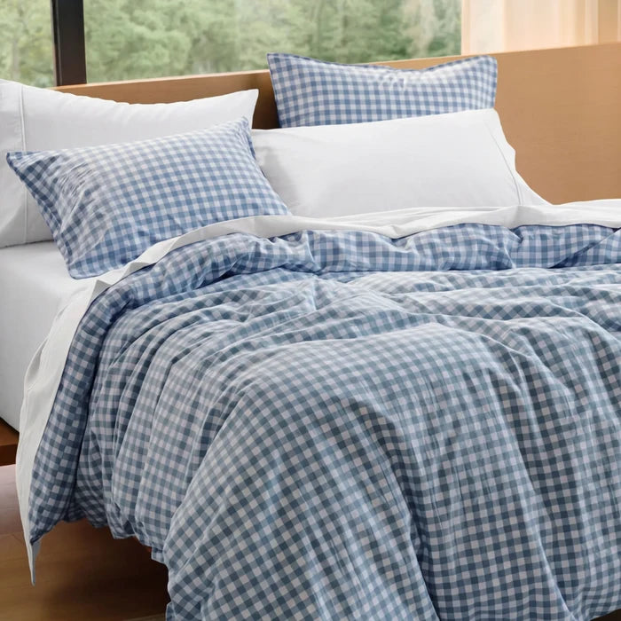 Blue gingham washed cotton bedding bundle on bed