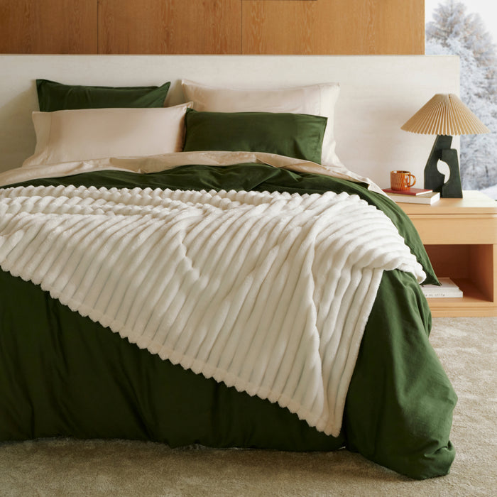 Organic Cotton Modern Cozy Bundle: green bedding and plush white textured blanket on bed.
