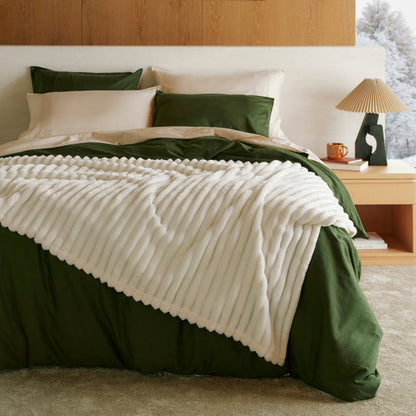 Organic Cotton Modern Cozy Bundle: green bedding and plush white textured blanket on bed.