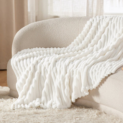 GentleSoft off-white ribbed organic cotton blanket on cozy sofa