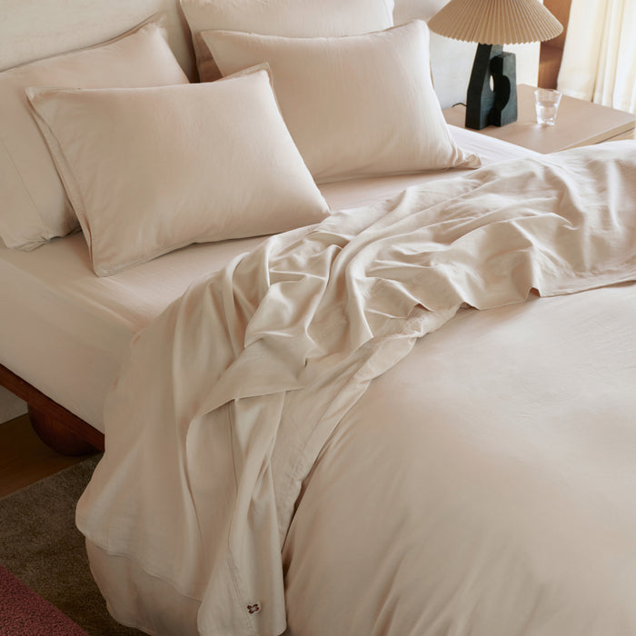 Organic cotton bedding bundle in beige, soft sateen duvet cover with floral embroidery.