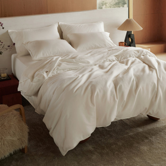 Organic Cotton Smart Warmth Bundle: white duvet cover and sheets on bed.