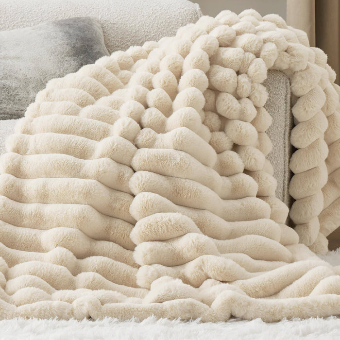 GentleSoft Plush Stripe Blanket in cream, draped over a sofa, showcasing its soft faux fur texture and cozy design.