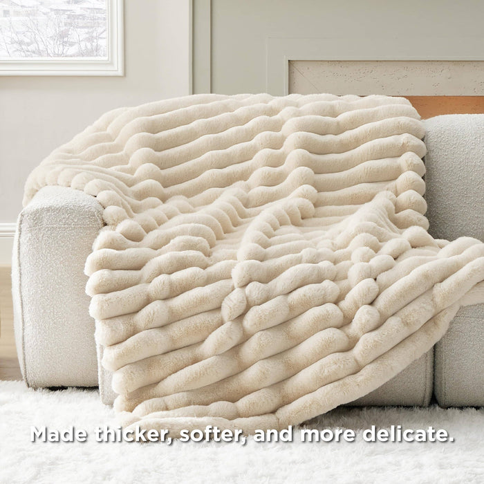 GentleSoft plush cream blanket with wavy stripe texture draped on a sofa, highlighting its soft, luxurious faux fur.