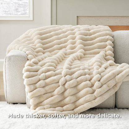 GentleSoft plush cream blanket with wavy stripe texture draped on a sofa, highlighting its soft, luxurious faux fur.